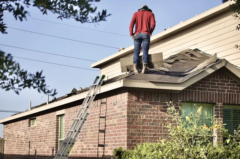Professional roofer working on a residential roof in Inkster